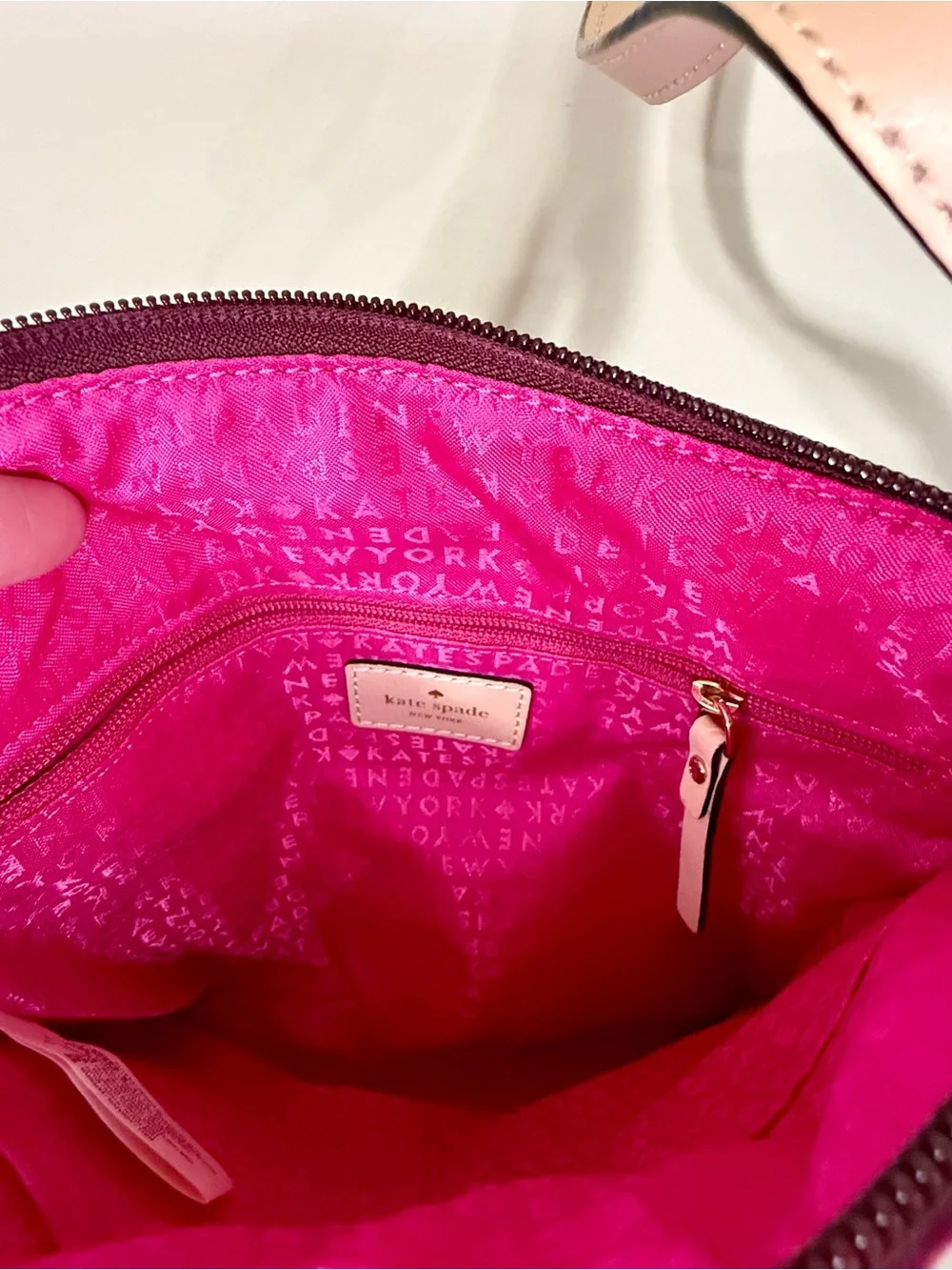 kate spade burgundy crossbody with beige strap and gold plaque